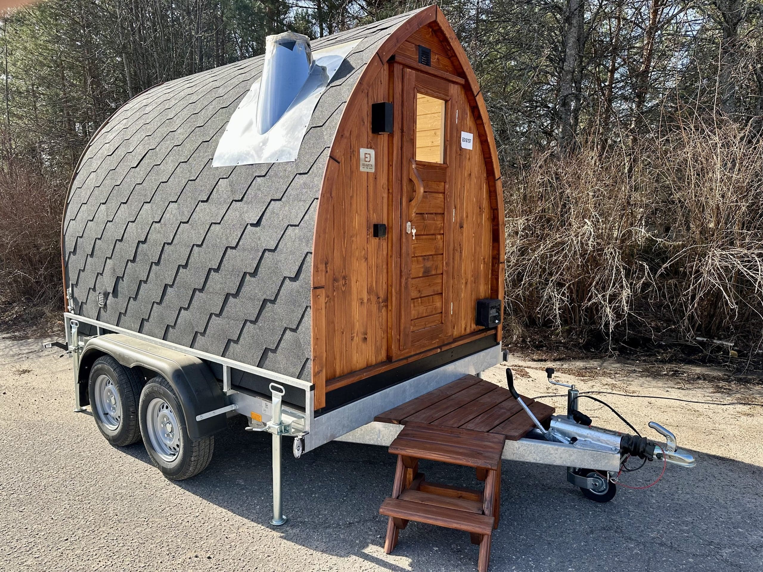 Pod-style mobile sauna trailer with shingle roof